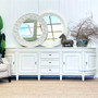 The Francia Grande Sideboard in distressed white commands attention in any living room, combining Canalside Interiors' craftsmanship with a Hamptons aesthetic