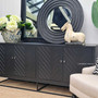A harmonious blend of Hamptons style and coastal charm, this distressed black herringbone sideboard at Canalside Interiors elevates modern decor