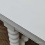 Close-up of the table's unique paint-stroke patina, highlighting the hand-finished and hand-distressed techniques that add to its charm.