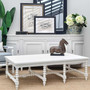 View of the Bobbin Coffee Table at Canalside Interiors, displaying its distressed brushed white finish and eight hand-turned bobbin legs.