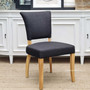 Side profile emphasizing the chair's curved hardwood legs in a distressed natural finish, adding a touch of rustic charm to its contemporary design.