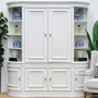 Frontal view of the Francia Curved Wall Unit in distressed white, embodying a blend of classic and modern design