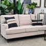 Sloan Rolled Arm Sofa as part of a curated living space, the cream tone contrasting beautifully with dark wood flooring