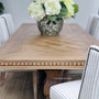 Shot emphasizing the Berenson table's carved details, blending traditional craftsmanship with modern design elements.