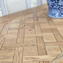 Close up detailed view of the parquetry top of the Berenson table, showing depth in finish and durability