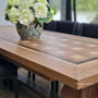 Side view of the Chambers Parquetry Dining Table, emphasizing the symmetry and beauty of the inlay work in a classical dining room