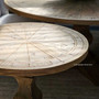 Elevated view of the Danbury Round Table's top, highlighting the intricate parquetry detail and weathered oak texture