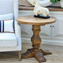Full view of the Danbury Oak Parquetry Round Side Table, anchoring a bedroom setting with its genuine oak provenance.