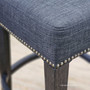 Close-up of the Montague Bar Stool's nailhead trim, adding a touch of coastal charm to this quality bar stool
