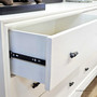 Detailed shot of the Camille Chestâ€™s metal runners, emphasizing smooth functionality in a classical bedroom setting