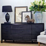 The curved edge of the Claremont Rattan Chest, marrying modern bedroom style with classical, coastal charm