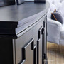 Close-up on the elegant trim and subtle distressing of the black Leontine Sideboard, perfect for a timeless living room setting