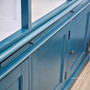 Close-up of the minor distressing on the teal green exterior of the Grange Wall Unit, highlighting its timeless coastal appeal