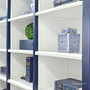 Close-up of the white interior shelving within the navy blue Grange Wall Unit, displaying timeless design | Coastal Chic