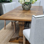 The table set against the backdrop of a luxurious open dining room, illustrating its versatility across various room settings.