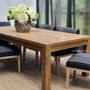Angled view emphasizing the Hayworth Tables reclaimed oak's texture, adding character to a modern dining space.
