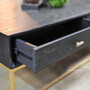 Close up detail of the St Lucia Coffee Table drawer showing metal runners and the gold gilded base