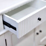 Close up view of the metal drawer runners of the Louis Curved Sideboard in white
