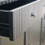 View of an open drawer on the Louis Curved Buffet, illustrating storage space and metal drawer runner.