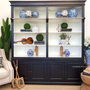 Front view of the Grange Wall Unit showcasing its elegant black exterior with a contrasting white interior.