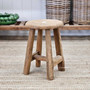 Angled front view of the Vintage Teak Round Stool, emphasizing its minimal yet bold profile.