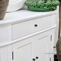 Angled shot of the Louis Curved Sideboard’s drawer front, showing the ribbed fluting texture and soft finish.