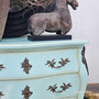 Three-quarter view styled with pottery and vintage accents, creating a relaxed, refined vignette.