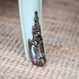 Side angle focusing on the flared leg design, with visible distressing along the base and aged brass hardware