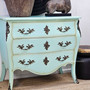 Angled front view, highlighting the soft aqua finish and sculptural curves.