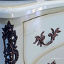 Close-up of the carved side bracket detail, featuring patina contrast and elegant lines.