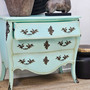 Angled view with drawer slightly open, showcasing storage function beneath its decorative façade.