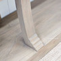 Leg detail from a low angle, capturing the solid stance and artisan flair.