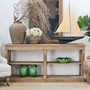 Console styled with a mirror above, creating a focal point in a transitional space.