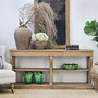 Console styled with vintage books and stone vessels, perfect for timeless interiors.