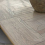 Parquetry tabletop detail showing hand-finished craftsmanship on the Chesterton dining table.