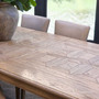 Close-up of hand-laid oak parquetry tabletop with border inlays on the Chesterton dining table.
