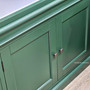 Detailed view of the base door panel showcasing the hand-applied satin finish, highlighting the quality timber grain beneath the bold green hue.
