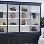 Angled perspective from the left side, showing shelf depth and refined black painted finish.