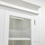 Zoomed-in shot of the glass door hinges, bevelled glass and frame joinery, showcasing craftsmanship.