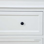 Close-up of the shaker-style drawer fronts with brass knobs for a clean, timeless contrast.