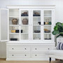 White shelves with doors ajar and arranged with warm timber accents for a country-inspired setting.