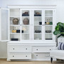 Glass doors open with books and ceramics styled to highlight generous display capacity and some base drawers open