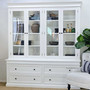 Shelving arranged with coral, books, and black-and-white accents for coastal styling.