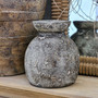 Malara pot vessel in charcoal-toned clay, styled solo as a sculptural focal point on a shelf or sideboard.