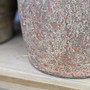 Detail shot of the Sekar’s textured clay surface, with visible pitting and patina variations.