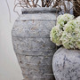 Ravena planter styled with twisted branches, making a bold statement in a natural, rustic vignette.