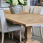 Angled shot of the Newquay Dining Table highlighting the elegant pedestal base and relaxed Hamptons aesthetic.