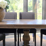 Side profile of the Berenson oak parquetry dining table with both extensions open.