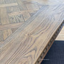 Close-up of parquetry pattern on Cigar oak tabletop showing rich wood tones.