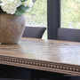 Side profile of the 245cm Cigar oak dining table showing pedestal base and carved apron.
